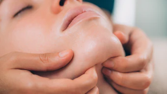 Beautiful Woman Receiving Chin and Jaw Skin Lifting Massage