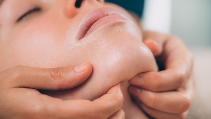 Beautiful Woman Receiving Chin and Jaw Skin Lifting Massage
