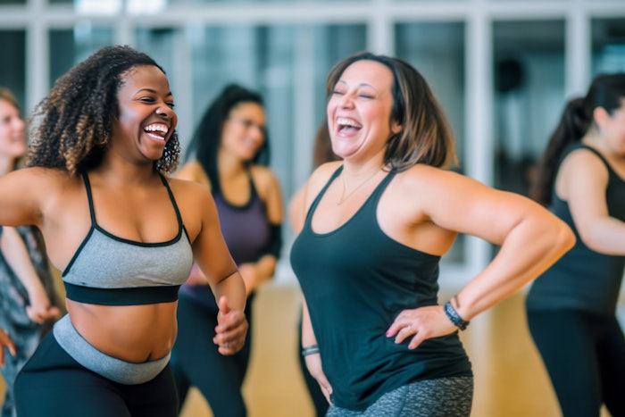 Middle-aged women enjoying a joyful dance class, candidly expressing their active lifestyle through Zumba with friends, generative ai