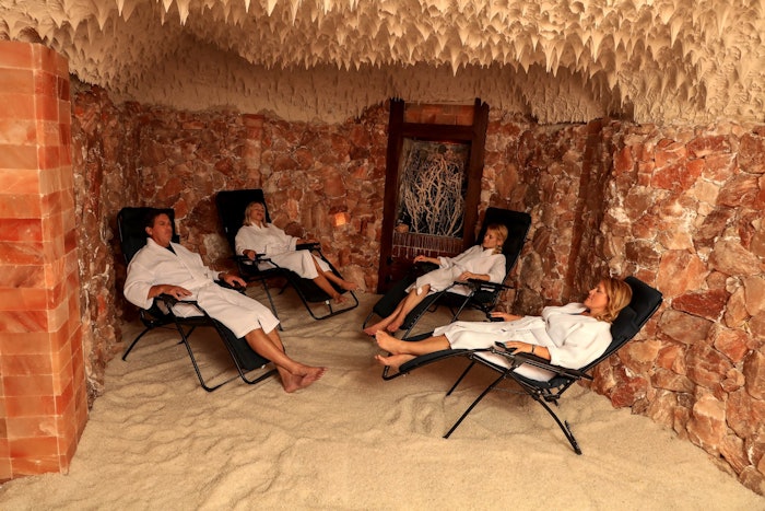 Four people relaxing in Salt Spa St. Augustine's Himalayan salt cave, halotherapy
