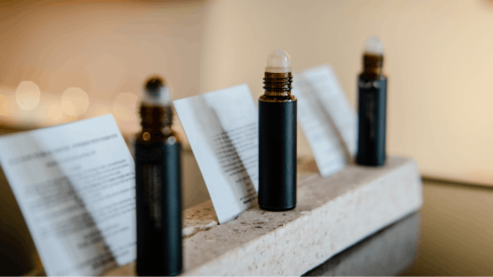Roll on perfume essential oil in dark brown bottle packaging.