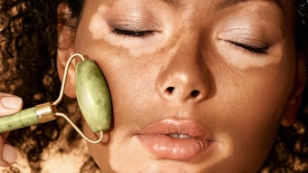 Woman using jade roller