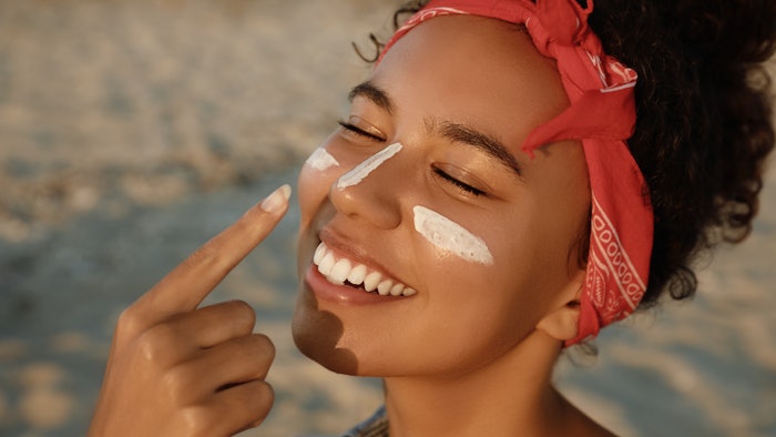 Woman Using Sun Care