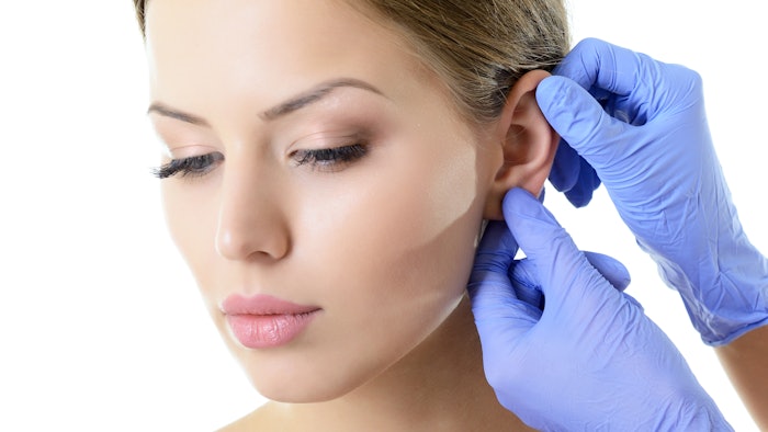 Young woman face with beauty treatment ear plastic isolated