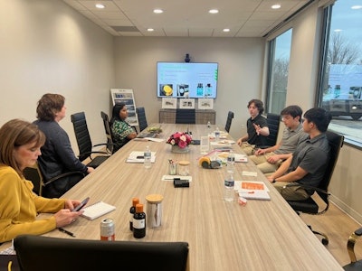The visit included discussions regarding ongoing product development initiatives led by Sally Washlow (mentor), Alex Bozarth, Logan Lyons, and Ryan Mendelson showcasing their enthusiasm for innovation.