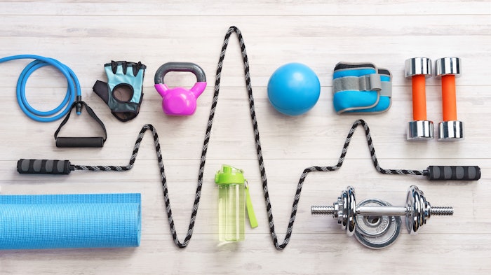 Sports equipment on a white wooden background. Top view. Motivation