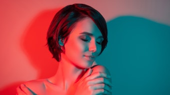 Photo of relaxed joyful dreamy stunning short hairstyle woman hug herself isolated red neon light color background