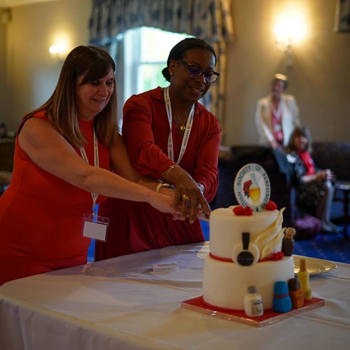 British Society of Perfumers' president Julie Dunkley (L) and vice president Denise McLaverty (R) cutting the anniversary cake at the ODS.