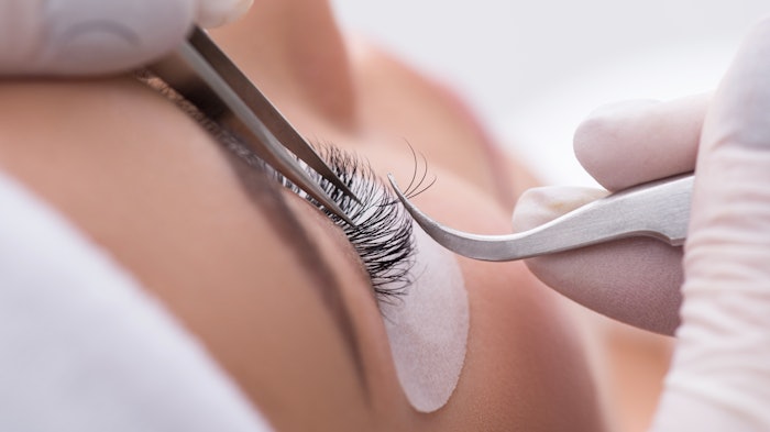 Woman getting eyelash extensions