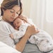 Loving mom carying of her newborn baby at home