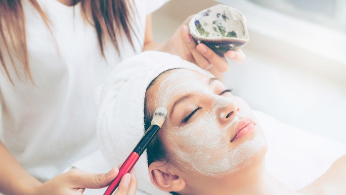 Beautiful woman having a facial treatment at spa