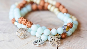 Mineral stone amazonite and tree pendant bead spiritual bracelet on natural wooden background