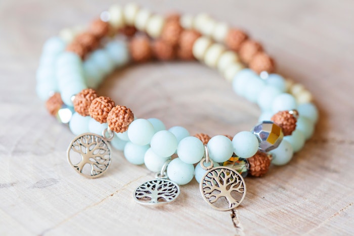 Mineral stone amazonite and tree pendant bead spiritual bracelet on natural wooden background