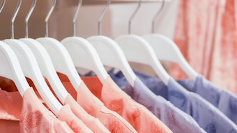 Womens pajamas hang on store hangers. Selling womens pajamas in the market. Advertising, sale, fashion concept. Dresses in a row