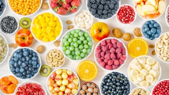 Berries, fruits and nuts on a white wooden background. Vegetarian food with flavonoids.