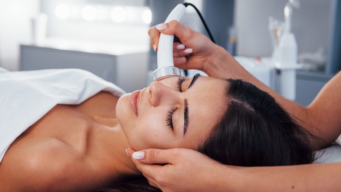 Woman getting facial with spa device