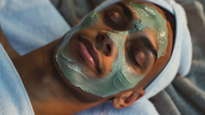 Man at the spa with a mask on his face