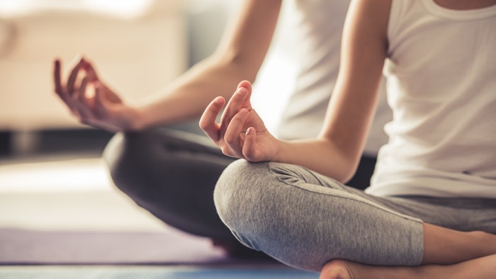 Mom and daughter doing yoga