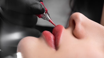 Woman having a lip blushing procedure in the spa