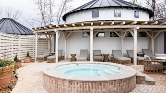 Exterior of The Spa at Nicewonder Farms and Vineyards, white yurt with lounge chairs and hot tub in foreground