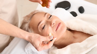 older woman getting an anti-aging facial in the spa