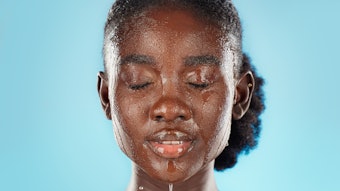 Young woman washing her face