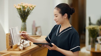 Spa salon manager checking price list and procedure description