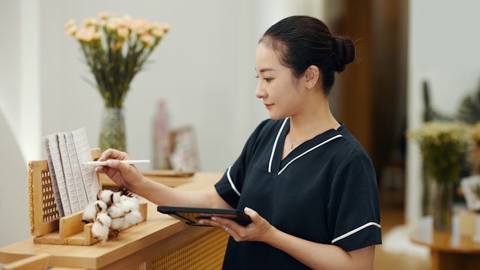 Spa salon manager checking price list and procedure description