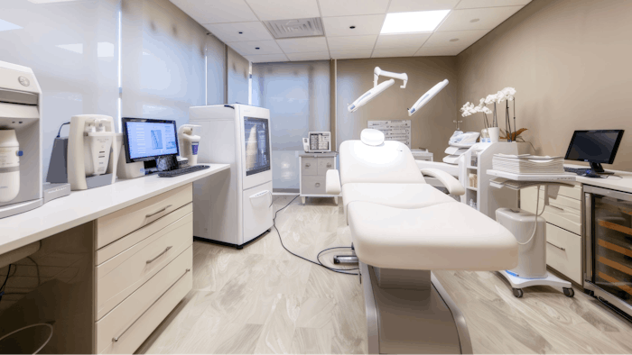 Advanced biorevitalization devices, including lasers and microneedling pens, organized in a sleek, modern treatment room. the clean, professional setting features state-of-the-art equipment, white chairs, and sophisticated artwork.