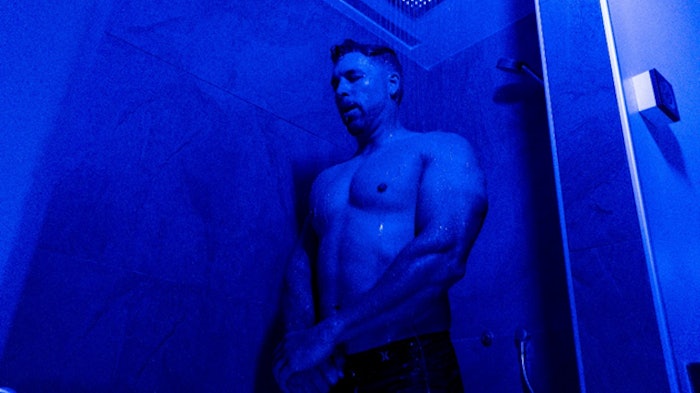man standing in sauna shower
