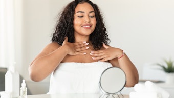 woman touching her neck and decollete