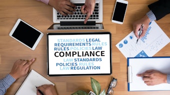 Compliance on a computer screen next to a desk