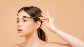Woman shaping her natural brows
