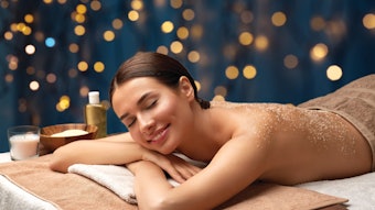 Woman having a salt scrub in the spa during the holidays