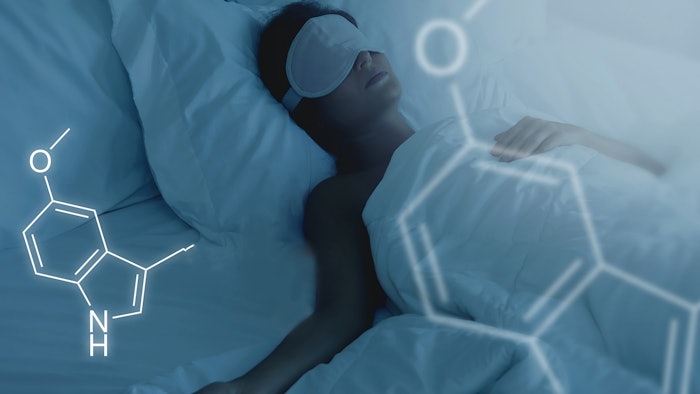 Woman sleeping peacefully in bed as outlines of molecules float above.