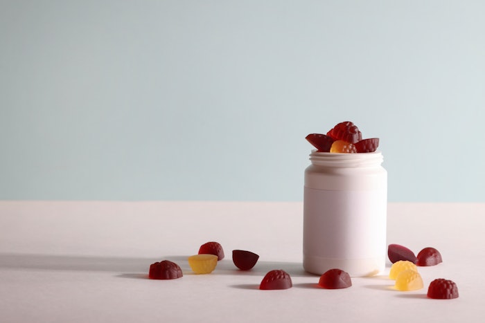 chewable supplements, nutritional gummies, edible health concept. colorful marmalades and bottle for your mock up or design. copy space