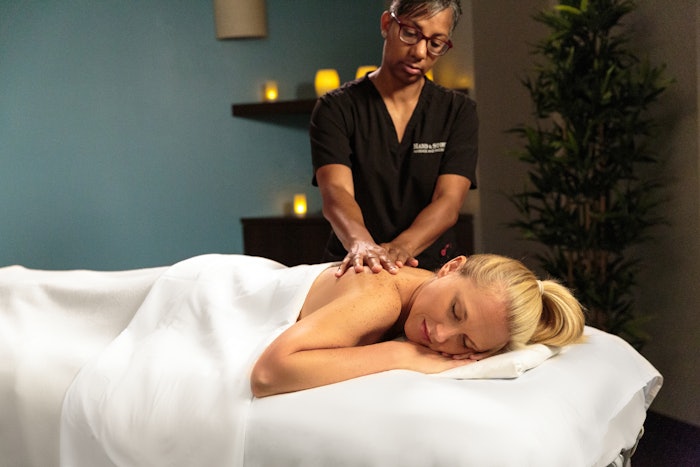 Hand & Stone Massage Therapist Massaging Client