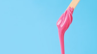 Pink wax dripping off of a stick