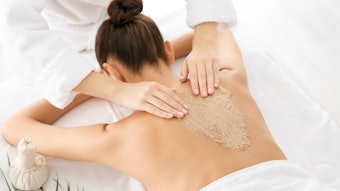 Woman getting a body scrub service at the spa