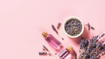 Lavender essential oil and perfume on pink
