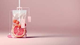 Close-up Of Various Fruit Slices In Saline Bag Dip In Water Against pink Background