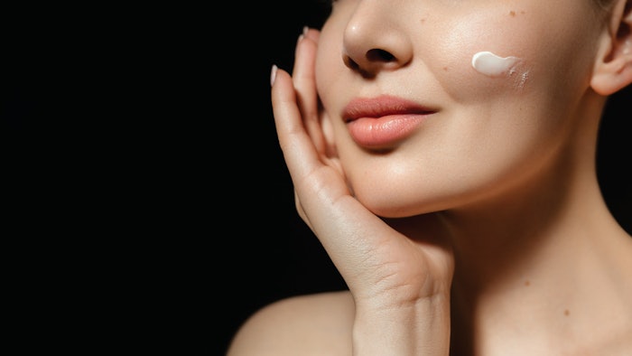 CT2502 Schaal hero image woman applying lotion to cheek image from nose down