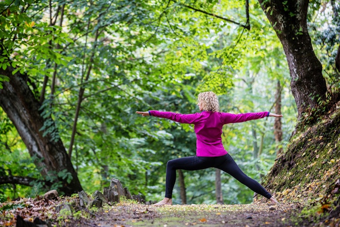 Women doing yoga in the forrest