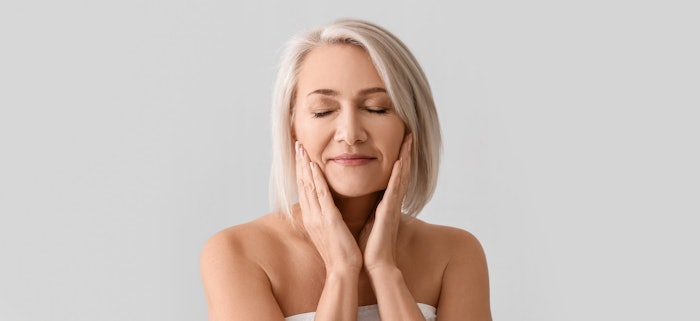 woman touching her face