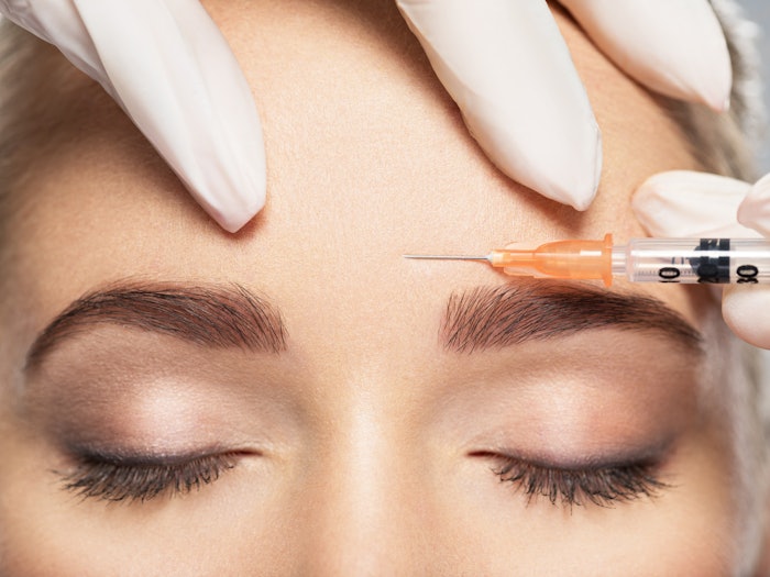 Woman receiving an injection in her face