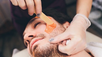 Male facial waxing at a spa