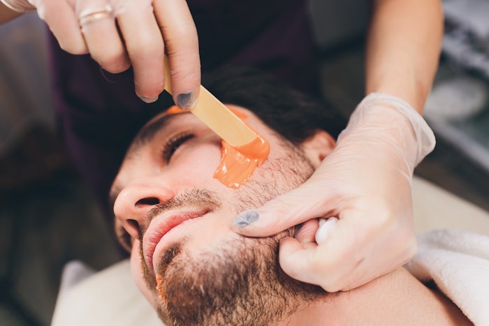 Male facial waxing at a spa