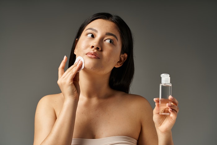 Beautiful Asian Woman Cleansing Face Some Acne Adobe Stock 718183258