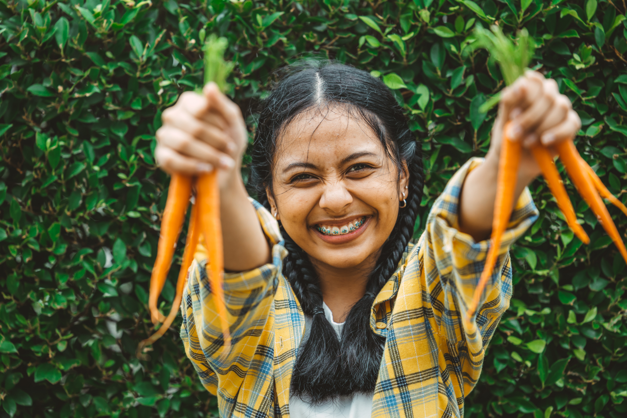Young Woman Excited Holding Up Carrots Adobe Stock 504354316