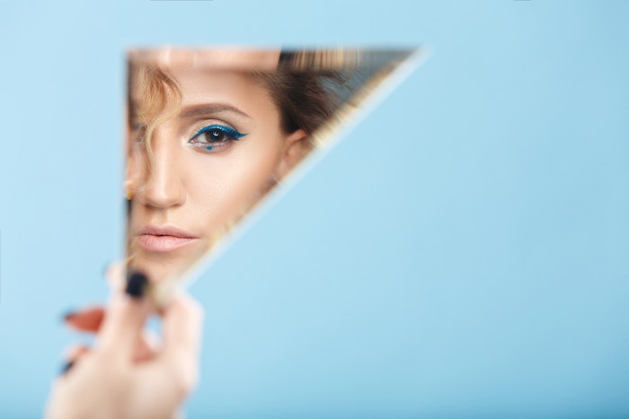 Woman Peeking Triangle Mirror Blue Background Bold Eye Makeup Adobe Stock 242260080